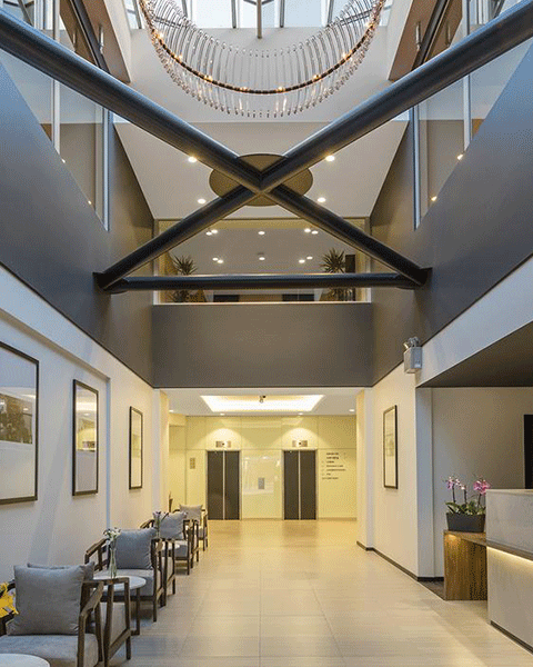 Photo of a hotel hallway leading up to the elevators